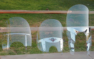 The Harley windshield (left) and the Yamaha Windhield (right) pop off in a few seconds without any tools. The Kawasaki shield (center) requires a few minutes with an allen wrench. The Harley windshield (left) and the Yamaha Windhield (right) pop off in a few seconds without any tools. The Kawasaki shield (center) requires a few minutes with an allen wrench.